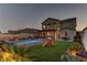 Spacious backyard with a sparkling pool, green lawn, and an outdoor play area at 426 Port Reggio St, Las Vegas, NV 89138