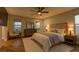 Relaxing primary bedroom with natural light, ceiling fan, and calming decor, offering a peaceful retreat at 426 Port Reggio St, Las Vegas, NV 89138