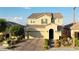 Charming two-story home featuring a brick driveway, a well-manicured lawn, and a two-car garage at 426 Port Reggio St, Las Vegas, NV 89138