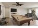 Bright game room featuring a billiard table, mounted television, ceiling fan, and comfortable seating for entertaining guests at 426 Port Reggio St, Las Vegas, NV 89138
