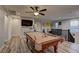 Open game room with pool table, mounted television, and fan with lots of space at 426 Port Reggio St, Las Vegas, NV 89138