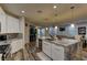 Open-concept kitchen with marble island, stainless steel appliances, and seamless flow to the dining and living area at 426 Port Reggio St, Las Vegas, NV 89138