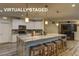 Modern kitchen featuring a marble island, white cabinets, and stainless steel appliances at 426 Port Reggio St, Las Vegas, NV 89138
