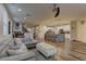 Spacious open-concept living room featuring wood floors and comfortable seating, connected to dining and kitchen areas at 426 Port Reggio St, Las Vegas, NV 89138