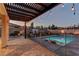 Beautiful backyard with a covered patio, pool with safety fence and ample seating at 426 Port Reggio St, Las Vegas, NV 89138