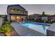 Stunning backyard showcasing a pristine pool, outdoor lounge chairs, lush greenery, and a covered patio area for outdoor enjoyment at 426 Port Reggio St, Las Vegas, NV 89138