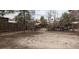 Large backyard area with trees, sheds, and some fencing at 4341 San Mateo St, North Las Vegas, NV 89032