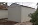 Exterior view of a detached garage or storage shed with vertical siding at 4341 San Mateo St, North Las Vegas, NV 89032