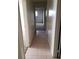 A view down the hallway with tile flooring and doorways at 4341 San Mateo St, North Las Vegas, NV 89032