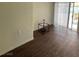 Bright living room with wood-look flooring and sliding glass doors to the outside at 4341 San Mateo St, North Las Vegas, NV 89032