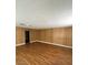 Spacious living room featuring wood paneling and wood-look flooring at 4341 San Mateo St, North Las Vegas, NV 89032
