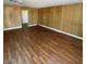 The living room features wood paneling and new laminate flooring at 4341 San Mateo St, North Las Vegas, NV 89032