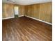 The living room features wood paneling and new laminate flooring at 4341 San Mateo St, North Las Vegas, NV 89032