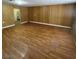 Spacious living room features wood paneling and hardwood flooring at 4341 San Mateo St, North Las Vegas, NV 89032