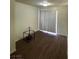 A bright living room with wood-look floors and a sliding glass door at 4341 San Mateo St, North Las Vegas, NV 89032