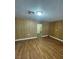 Living room with wood paneling and hardwood floors offering a unique aesthetic at 4341 San Mateo St, North Las Vegas, NV 89032