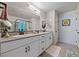 Modern bathroom with double vanity, granite countertops, and a walk-in shower at 4514 Sapphire Moon Ave, North Las Vegas, NV 89084