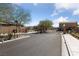 Gated community entrance featuring brick columns, mature trees, and desert landscaping at 4514 Sapphire Moon Ave, North Las Vegas, NV 89084