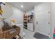 Functional laundry room with washer, dryer, storage shelving, and exterior access for added convenience at 4514 Sapphire Moon Ave, North Las Vegas, NV 89084