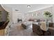 Bright living room with sectional sofa, ottoman, and ample natural light at 4514 Sapphire Moon Ave, North Las Vegas, NV 89084