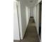 Hallway with wood-look floors and white walls, with doors leading to other rooms at 4560 Rancho Hills Dr, Las Vegas, NV 89119