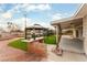 A backyard with a covered patio, gazebos and artificial turf at 4690 San Benito St, Las Vegas, NV 89121
