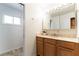 Bright bathroom featuring single sink vanity with granite countertop and patterned tile floors at 4690 San Benito St, Las Vegas, NV 89121
