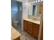 Bathroom features a single vanity sink, decorative patterned tile flooring, toilet, and updated fixtures at 4690 San Benito St, Las Vegas, NV 89121