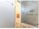 Bathroom featuring shower with glass door and patterned tile floors at 4690 San Benito St, Las Vegas, NV 89121