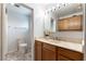 Bathroom featuring a mirror with lights, wood cabinets and colorful tile flooring at 4690 San Benito St, Las Vegas, NV 89121