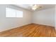 Well-lit bedroom featuring wood floors, ceiling fan, and a window at 4690 San Benito St, Las Vegas, NV 89121