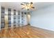 Bedroom featuring wood floors, ceiling fan, closet with mirrored doors, and natural light at 4690 San Benito St, Las Vegas, NV 89121