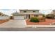 Traditional two-story home featuring solar panels, a two-car garage and desert landscaping at 4690 San Benito St, Las Vegas, NV 89121