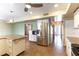 Bright kitchen with stainless steel refrigerator, granite countertops, and stylish pendant lights at 4690 San Benito St, Las Vegas, NV 89121