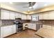 Updated kitchen featuring white cabinets, stainless steel appliances, and a cozy breakfast nook at 4690 San Benito St, Las Vegas, NV 89121