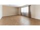 Spacious living room showcasing tile flooring, neutral walls, and natural light through sheer curtains at 4690 San Benito St, Las Vegas, NV 89121