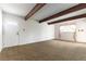 Cozy living room with exposed beams, carpeted floors, and a bright front door at 4690 San Benito St, Las Vegas, NV 89121