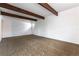 Expansive living room featuring exposed beams, a welcoming front door, and ample natural light at 4690 San Benito St, Las Vegas, NV 89121