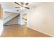 Open-concept living room shows staircase with a peek into the kitchen with white cabinetry at 4690 San Benito St, Las Vegas, NV 89121