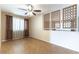 Living room with tile flooring, neutral walls, curtained window and decorative privacy screen at 4690 San Benito St, Las Vegas, NV 89121