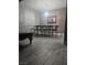 Dining room with wood-look flooring and a modern chandelier at 4900 Whisper Lake Ave, Las Vegas, NV 89131