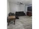 Comfortable living room with stylish tile flooring, dark brown sofas and ceiling fan at 4900 Whisper Lake Ave, Las Vegas, NV 89131