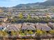 Picturesque aerial view of a home with a pool and desert landscaping in a gated community at 50 Carolina Cherry Dr, Las Vegas, NV 89141