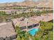 View of a home with a refreshing pool and desert landscaping in a planned community at 50 Carolina Cherry Dr, Las Vegas, NV 89141