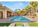 Resort-style backyard with a pristine pool, lush landscaping, and a serene outdoor living space at 50 Carolina Cherry Dr, Las Vegas, NV 89141