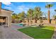Large pool features a lush grassy area, perfect for outdoor relaxation and entertainment at 50 Carolina Cherry Dr, Las Vegas, NV 89141