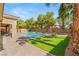 Lush backyard featuring a pool, seating, landscaping, and a sunny lawn at 50 Carolina Cherry Dr, Las Vegas, NV 89141