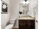 Elegant half bath with granite countertop, dark wood cabinetry, and modern fixtures at 50 Carolina Cherry Dr, Las Vegas, NV 89141