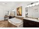 Luxurious bathroom with a large soaking tub, granite countertops, vanity area and elegant fixtures at 50 Carolina Cherry Dr, Las Vegas, NV 89141