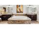 Luxurious bathroom with a large soaking tub, granite countertops, and elegant fixtures at 50 Carolina Cherry Dr, Las Vegas, NV 89141